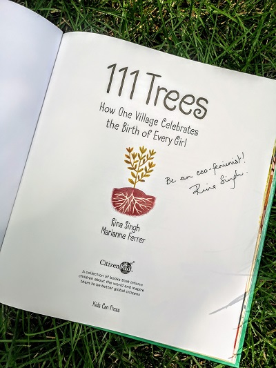 The title page from 111 Trees, written by Rina Singh, illustrated by Marianne Ferrer, signed by Rina Singh with the message, "Be an eco-feminist!"