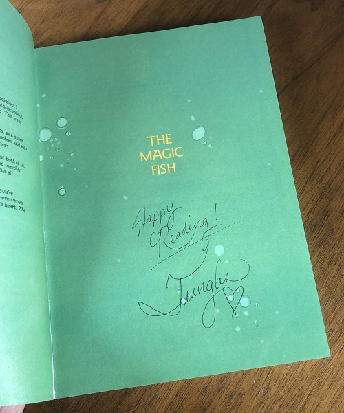 The title page of the graphic novel The Magic Fish, signed by the author Trung Le Nguyen.