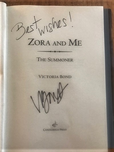 The title page of Zora and Me: The Summoner, signed by the author, Victoria Bond.