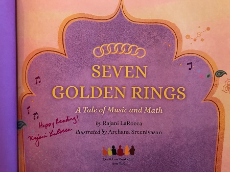 The title page of Seven Golden Rings, signed by the author Rajani LaRocca with the message, "Happy Reading!"