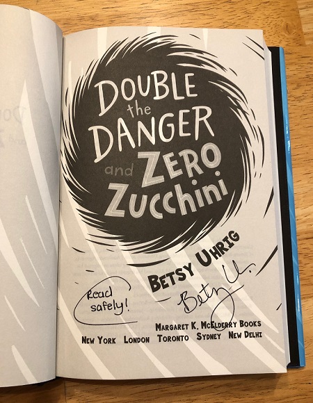 The title page of the novel Double the Danger and Zero Zucchini signed by the author Betsy Uhrig.