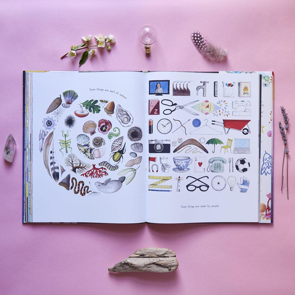 A spread from If You Come to Earth, written and illustrated by Sophie Blackall, showing a swirl of things from the natural world on the left side (shells, pinecones, etc.) and a swirl of human-created objects on the right (scisoors, wheelbarrows, eyeglasses, etc.).