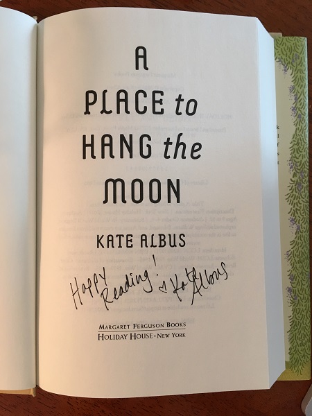The title page of A Place to Hang the Moon, signed by the author, Kate Albus, with the message, "Happy reading!"