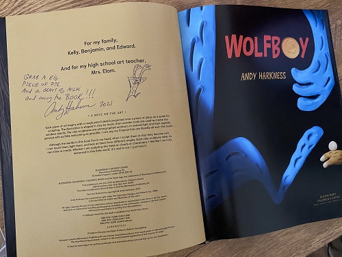 The copyright page of Wolfboy, signed by the author and illustrator, Andy Harkness, with the message, "Grab a big piece of pie and a glass of milk and enjoy the book!"