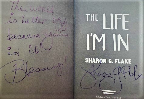 A title page from The Life I'm In, signed by the author, Sharon Flake, with the message, "The world is better because you're in it! Blessings!"