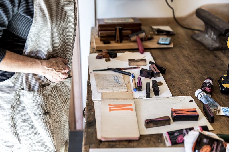 An interior image of Melissa Sweet's studio showing a worktable with ink stamps.