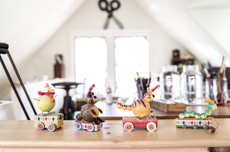 An interior image of Melissa Sweet's studio showing figurines used as models for her book Balloons over Broadway.