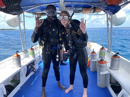 Miranda Paul in scuba diving gear with her husband and frequent collaborator, Baptiste Paul.