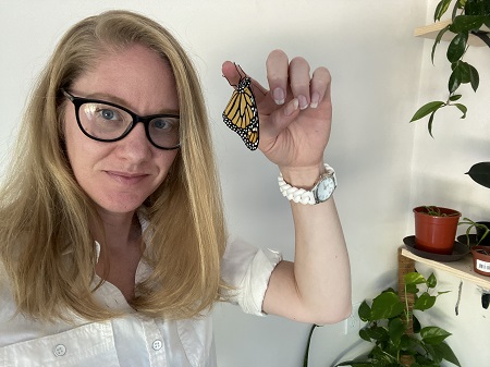 Miranda Paul with a monarch butterfly that she has raised.