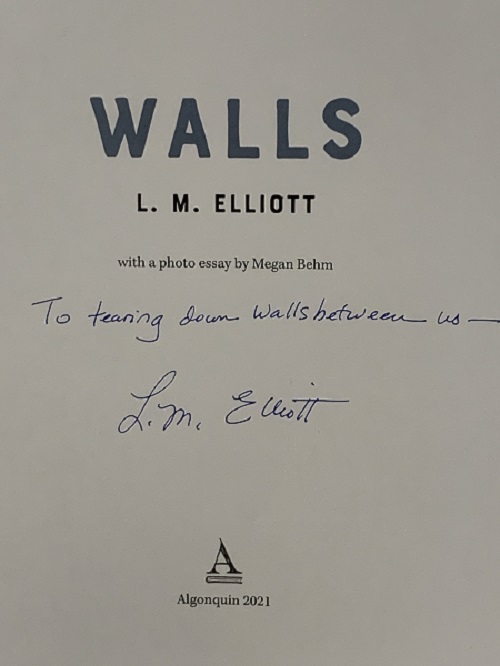 The title page of Walls, signed by the author, L.M. Elliott, with the message, "To tearing down the walls between us."