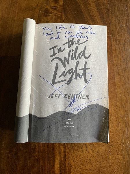 In the Wild Light signed by the author, Jeff Zentner, with the message, "Your life is yours and it can be new and wondrous."