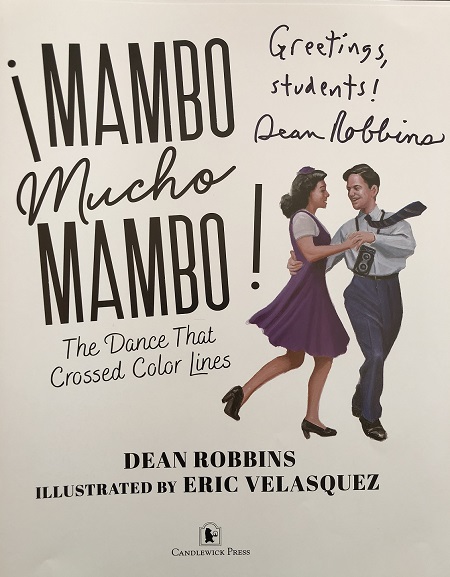 The title page of Mambo Mucho Mambo signed by the author, Dean Robbins, with the message, "Greetings, students!"