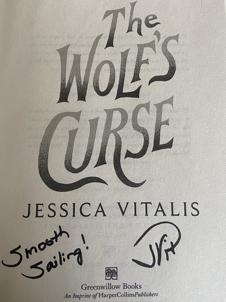 The title page of The Wolf's Curse, signed by the author with the message, "Smooth Sailing."