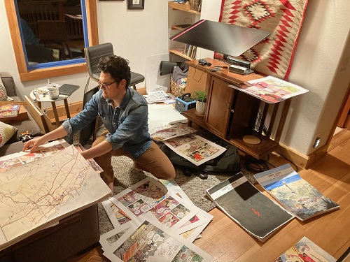 Jonathan Case in his work space, surrounded by original artwork for Little Monarchs.
