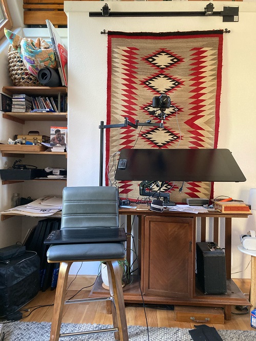 Jonathan Case's studio, showing a Native American blanket on the wall above a digital drafting table and digital sketching tools.