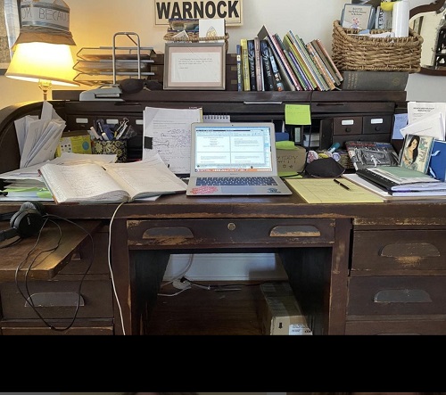 Author Laurel Snyder's desk, piled with papers and books.