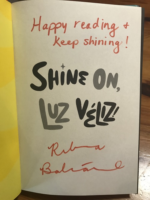 The title page of Shine On, Luz Veliz, sigend by the author, Rebecca Balcarcel.