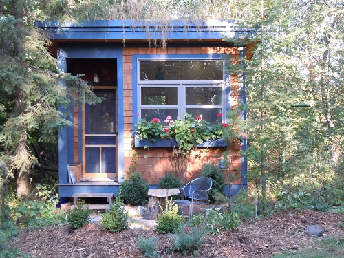 Margi Preus's writing studio in summer, with window boxes of blooming flowers.