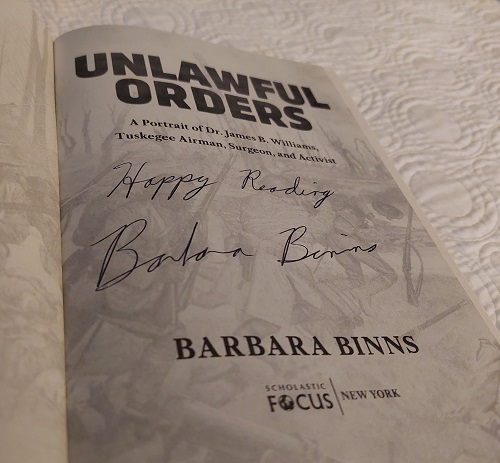 The title page of Unlawful Orders, signed by the author Barbara Binns, with the message, "Happy Reading"