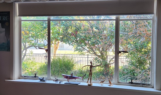 The window in author Claire Saxby's writing study, with a small sculpture of a whale on the window sill