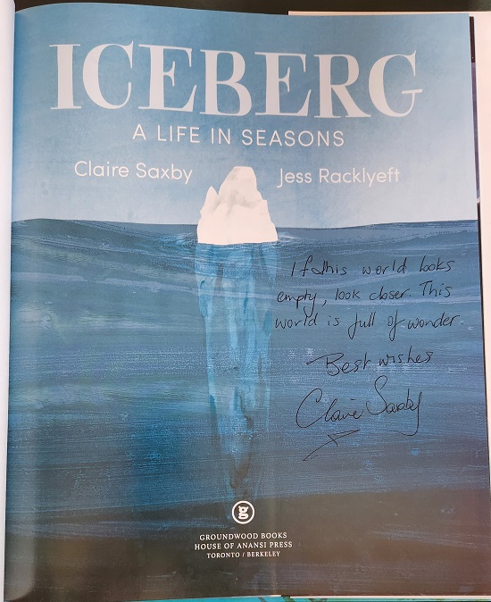The title page of Iceberg: A Life in Seasons, signed by the author, Claire Saxby, with the message, "If this world looks empty, look closer. This world is full of wonder."