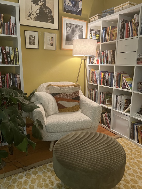 Author Lesa Cline-Ransome's office, showing a cozy reading chair in between large cubicle bookshelves filled with books.