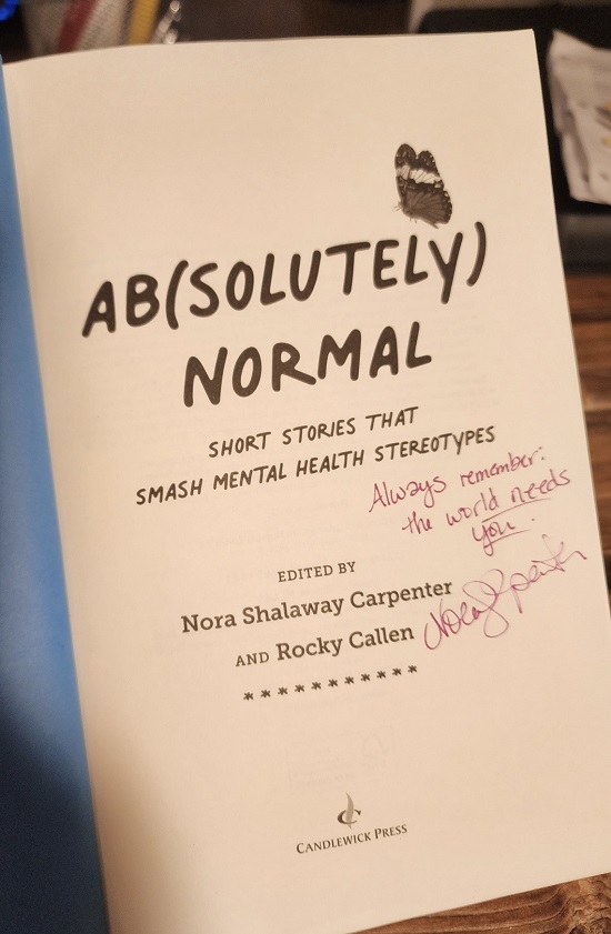 The title page of Ab(solutely) Normal signed by the co-editor Nora Shalaway Carpenter with the message, "Always remember: the world needs you."