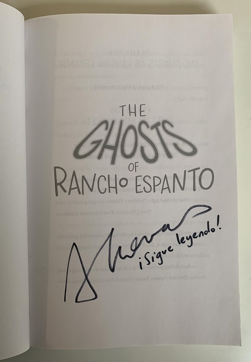 The title page of The Ghosts of Rancho Espanto, signed by the author, Adrianna Cuevas, with the message, "¡Sigue leyendo!"