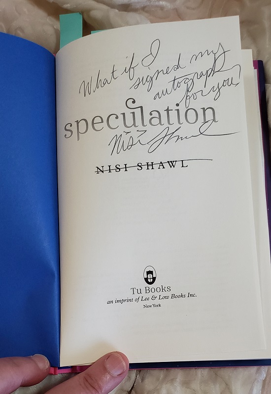 The title page of Speculation, signed by the author, Nisi Shawl, with the message, "What if I signed my autograph for you?"