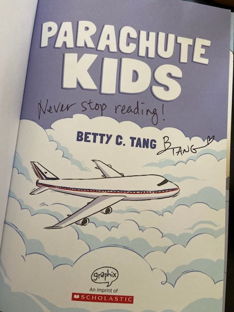 The title page of Parachute Kids, signed by the author and illustrator, Betty C. Tang, with the message, "Never Stop Reading!"
