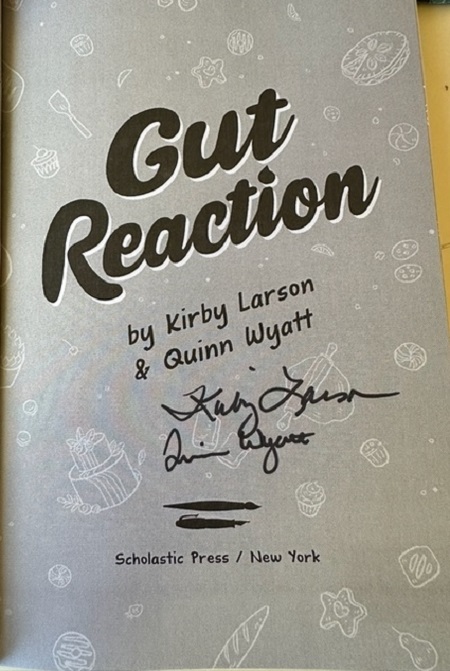 The title page of Gut Reaction signed by the authors, Kirby Larson and Quinn Wyatt.