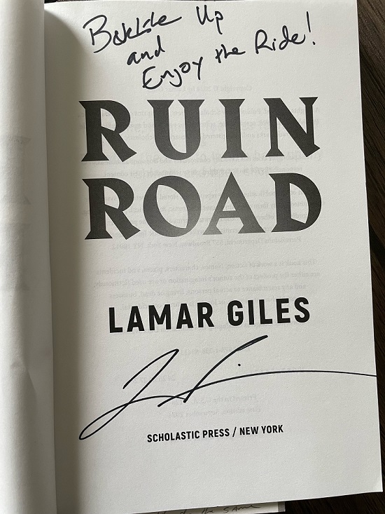 The title page of Ruin Road, signed by the author, Lamar Giles, with the message, "Buckle up and enjoy the ride!"