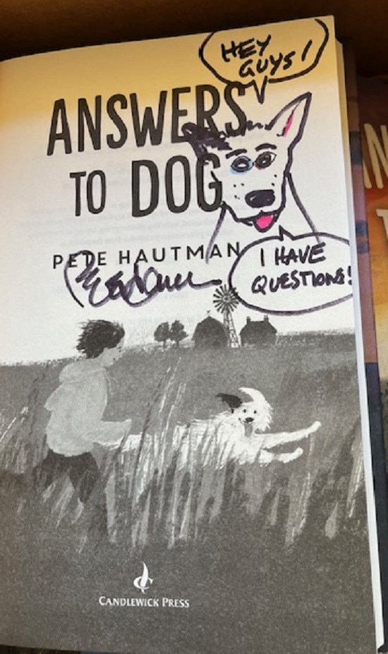 The title page of Answers to Dog, signed by the author, Pete Hautman, with a cartoon of a dog, and a speech bubble saying, "Hey guys! I have questions!"