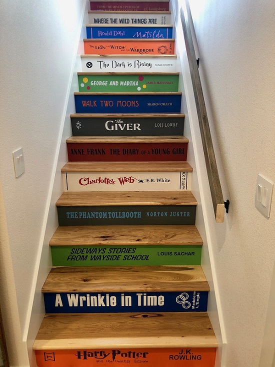 The stairs leading up to Lisl Detlefsen's attic study. Each stair riser is painted to look like the spine of a classic children's book.