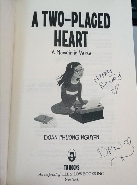 The title page of A Two-Placed Heart, signed by the author, Doan Phuong Nguyen, with the message, "Happy Reading!" 