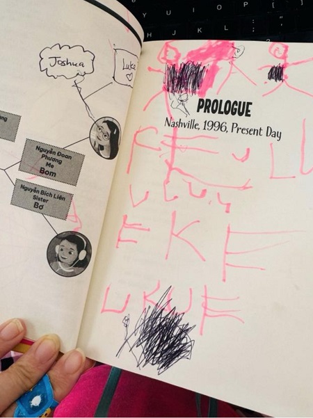 A page from A Two-Placed Heart featuring a family tree, over which the author's son has scribbled drawings and words in pen and marker.